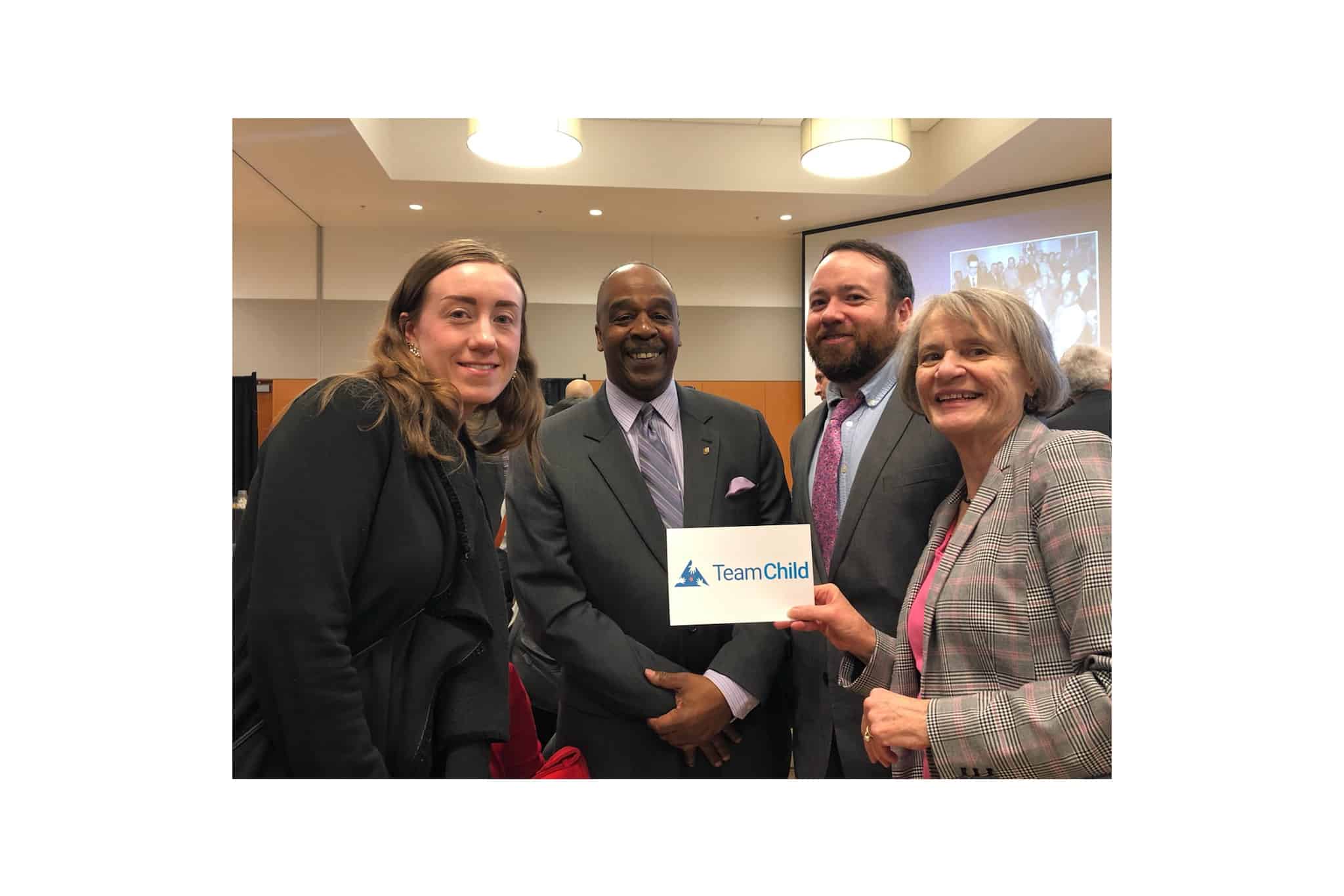 Color photo of Spokane Team: Britta, Dan and Rosey with Reverend Walter Kendricks at the Spokane County Bar Association Diversity Section’s luncheon.