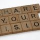 Scrabble game tiles spell out the words "Share Your Vision"