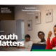 3 young people sit in a classroom listening to someone speaking. White text reads: Youth Matters. Logo for Glover Empower Mentoring appears in upper left corner.