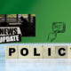 The word POLICY is spelled out on wooden blocks; to the upper right is a drawing of a hand and finger pressing a computer key with the word POST. Against a green background, a photo shows a young man in silhouette studying at a desk. A red car drives into frame behind him. Additional black and white text reads News Update.