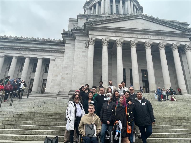 Porsche (L, middle row) is pictured with TeamChild staff and Youth Advisory Board members on the steps of the capitol building in Olympia.